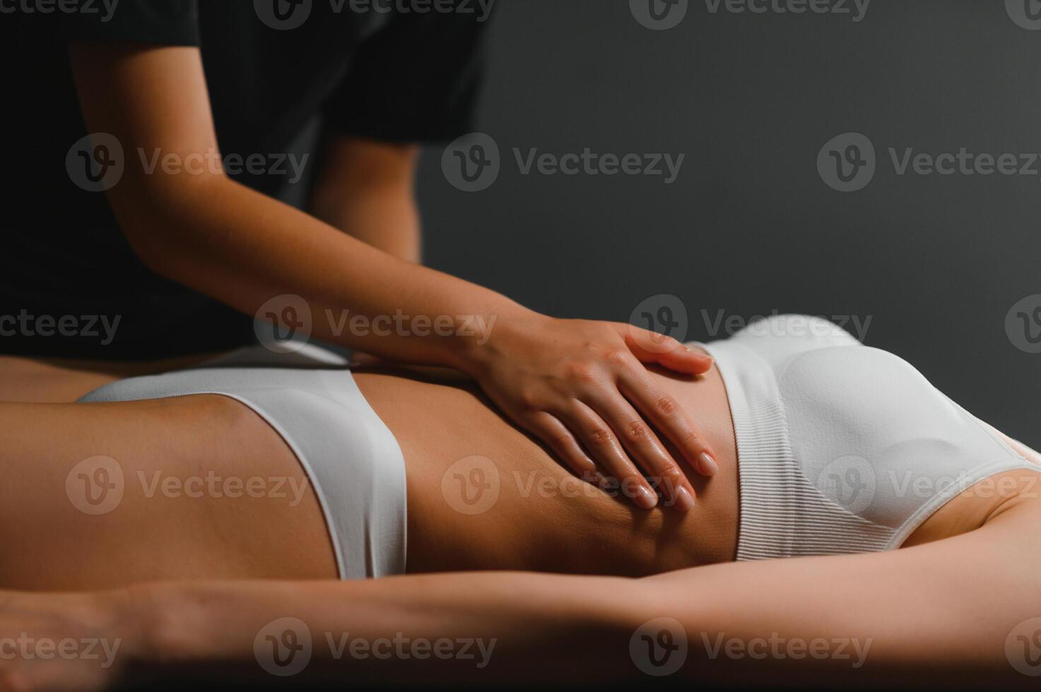 A woman receiving a belly massage at a beauty salon photo