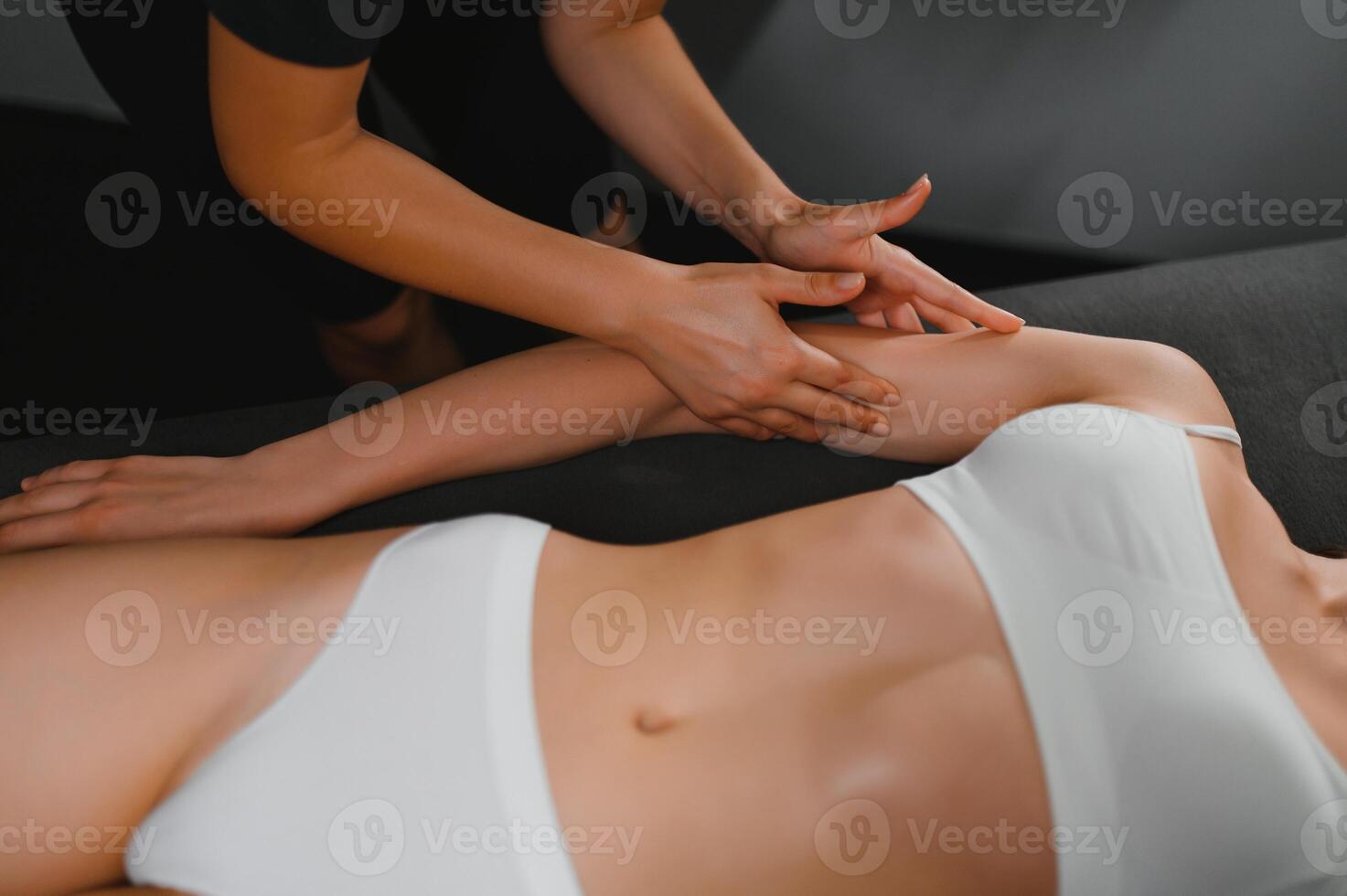 Woman receiving hand massage at beauty salon photo