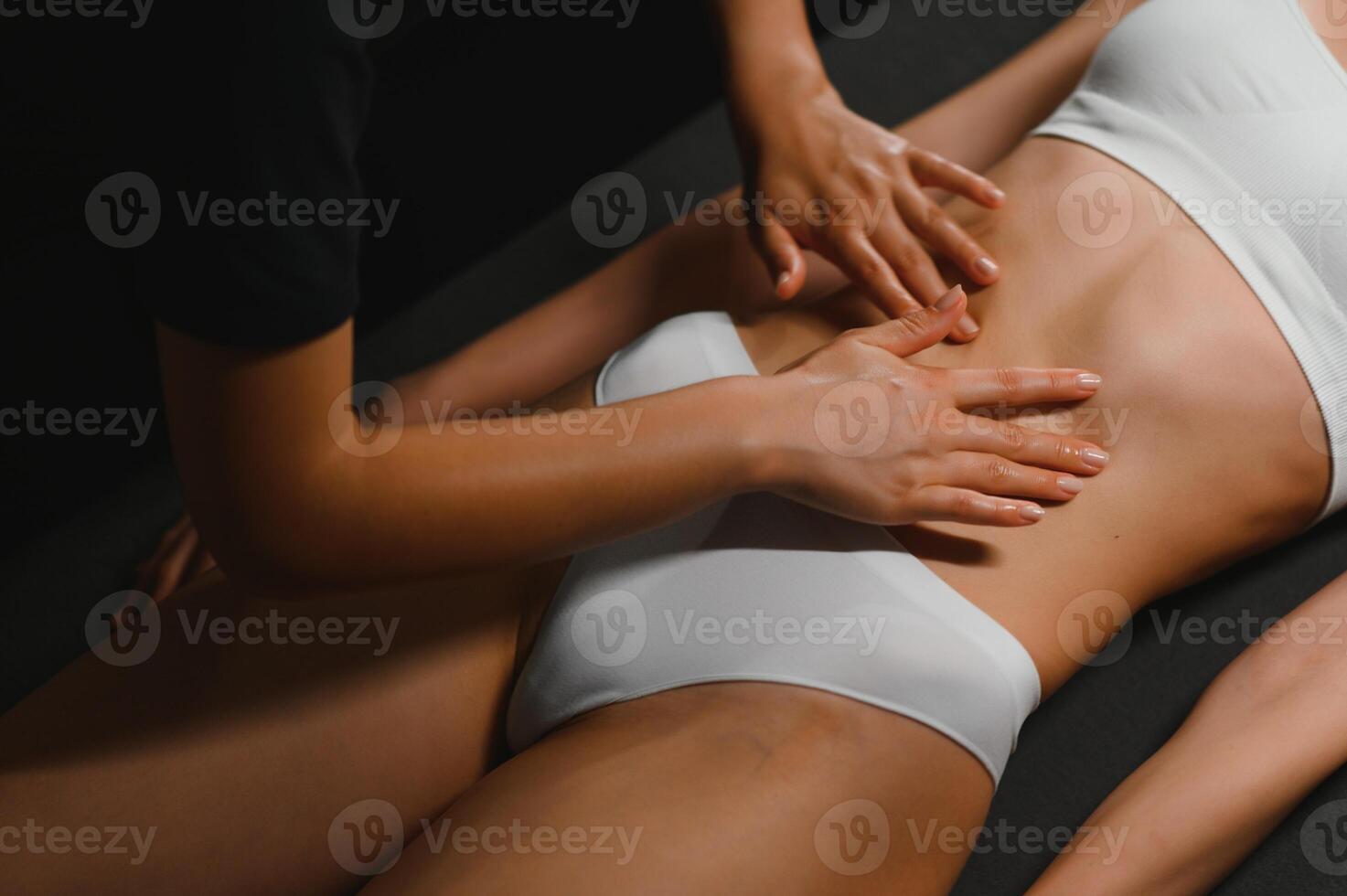 A woman receiving a belly massage at a beauty salon photo