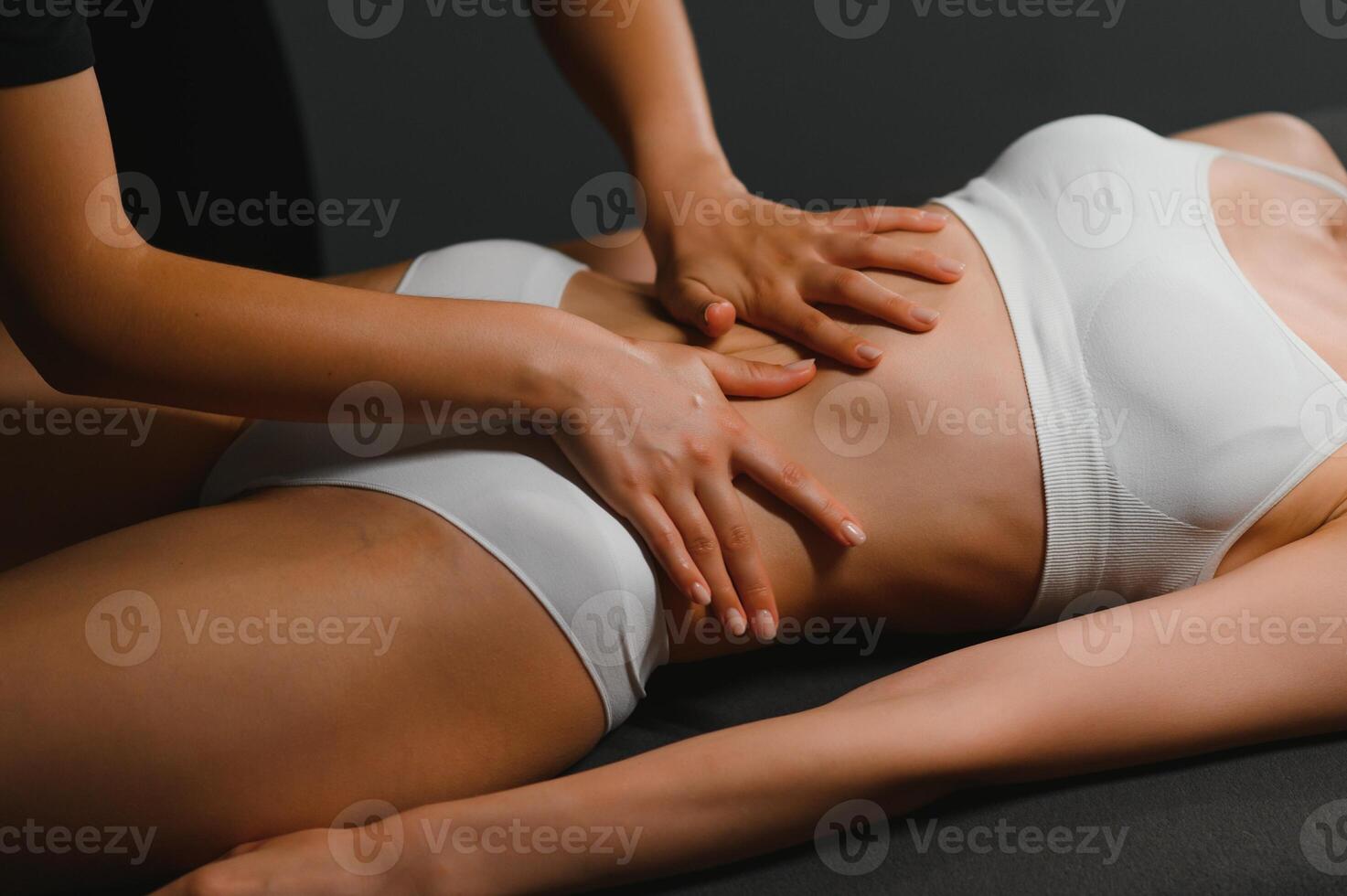 Masseur doing massage on woman body in the spa salon. Beauty treatment concept photo