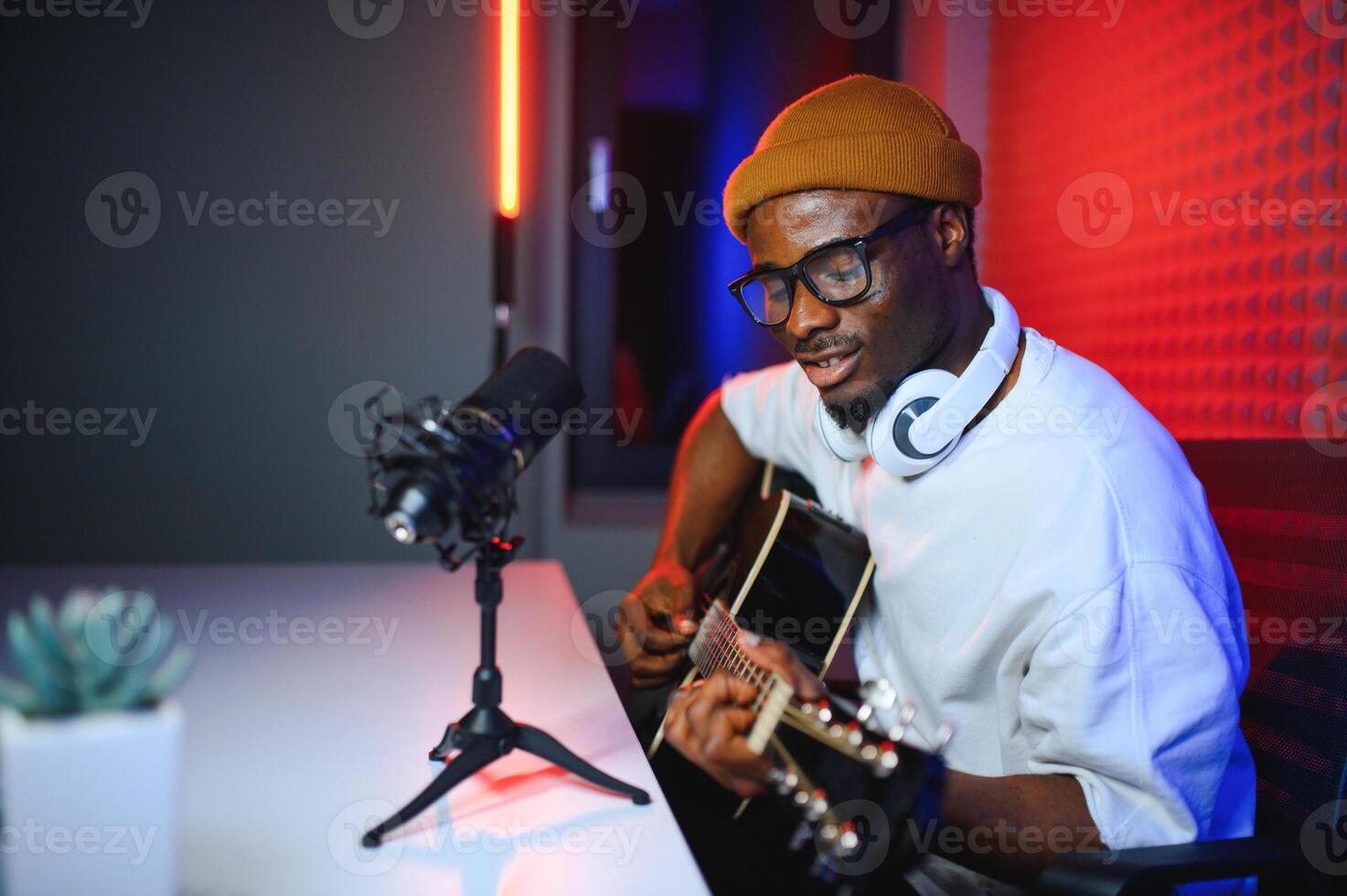 african american man with guitar in recording studio photo