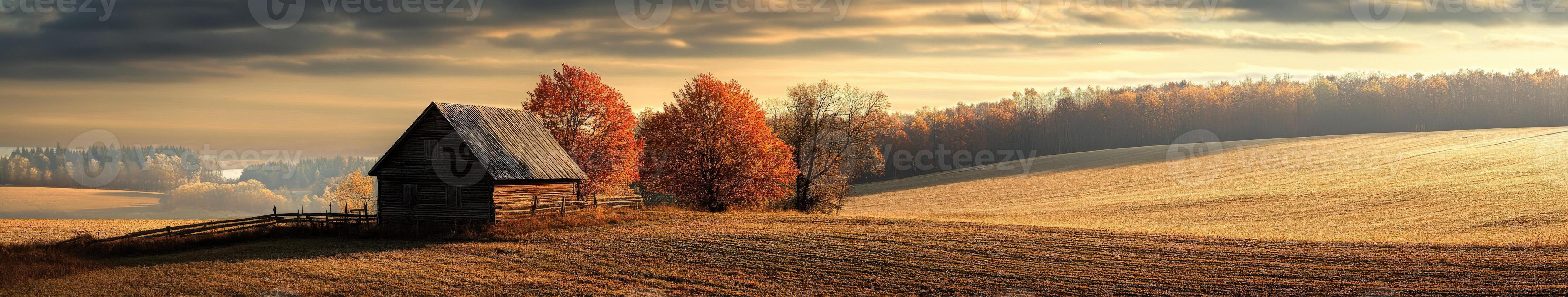 Golden autumn fields with rustic barn and vibrant foliage at sunset photo