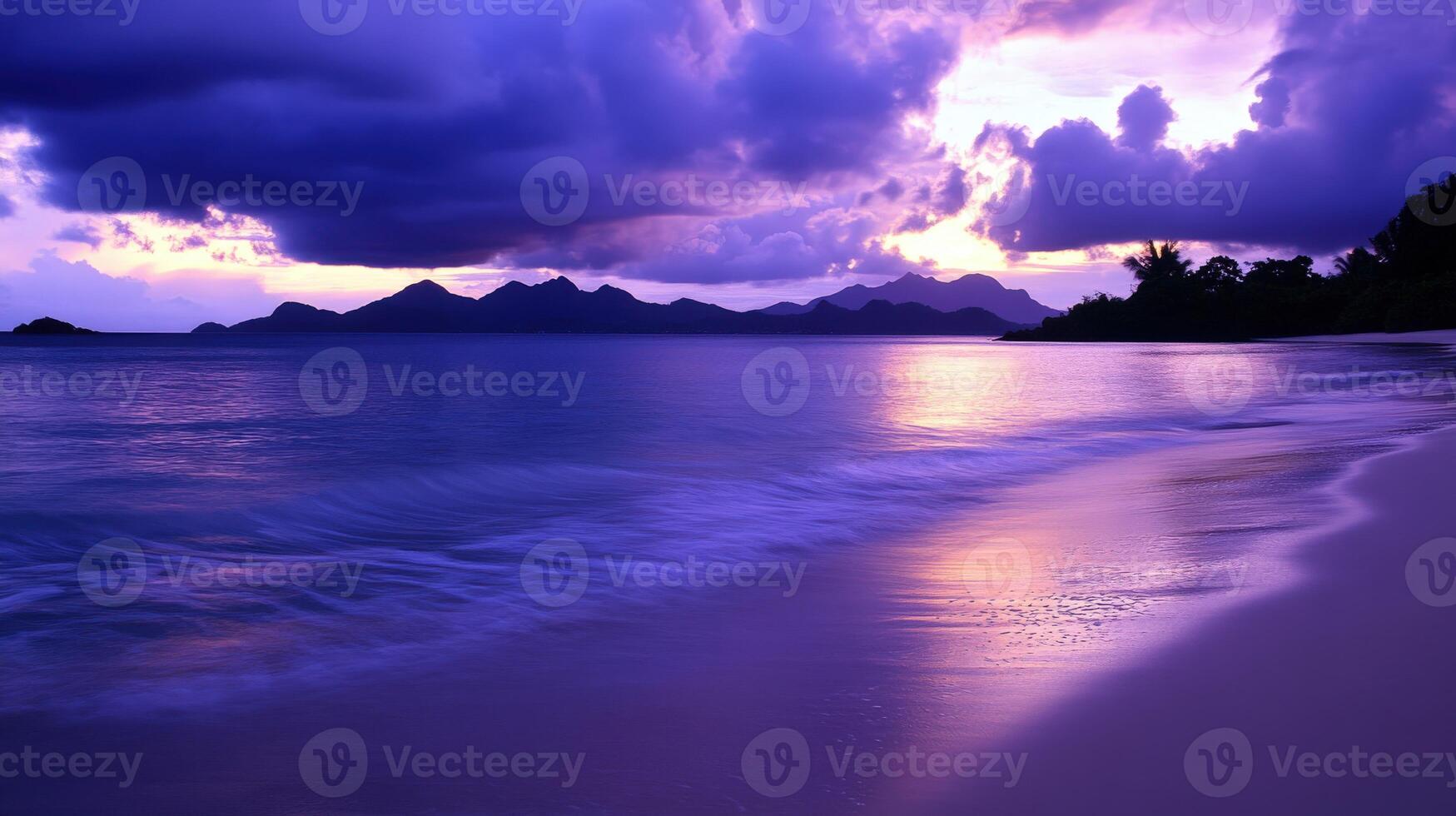 Tropical beach at dusk with tranquil waves and distant mountains photo