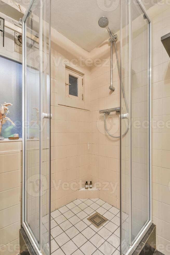 A shower stall with a glass door photo