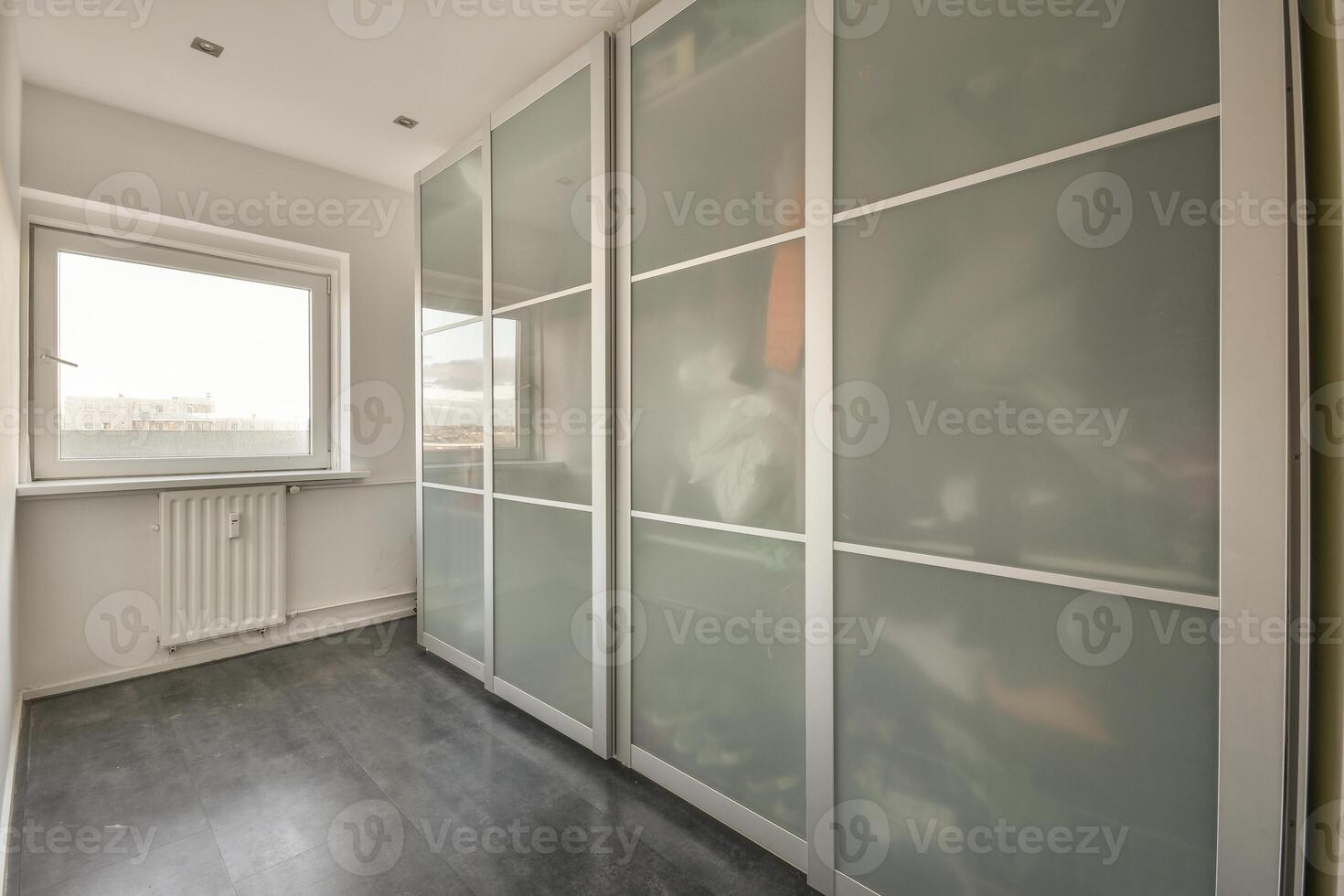 A room with a sliding door and a window photo
