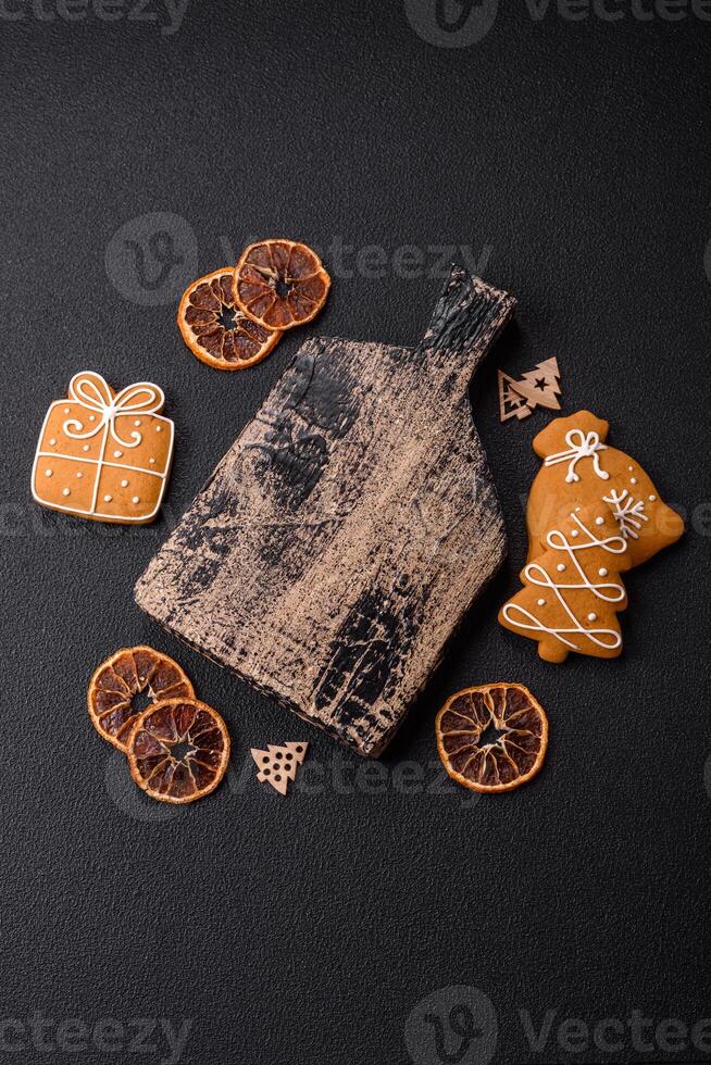 Empty wooden cutting board with copy space with gingerbread cookies and Christmas decor photo
