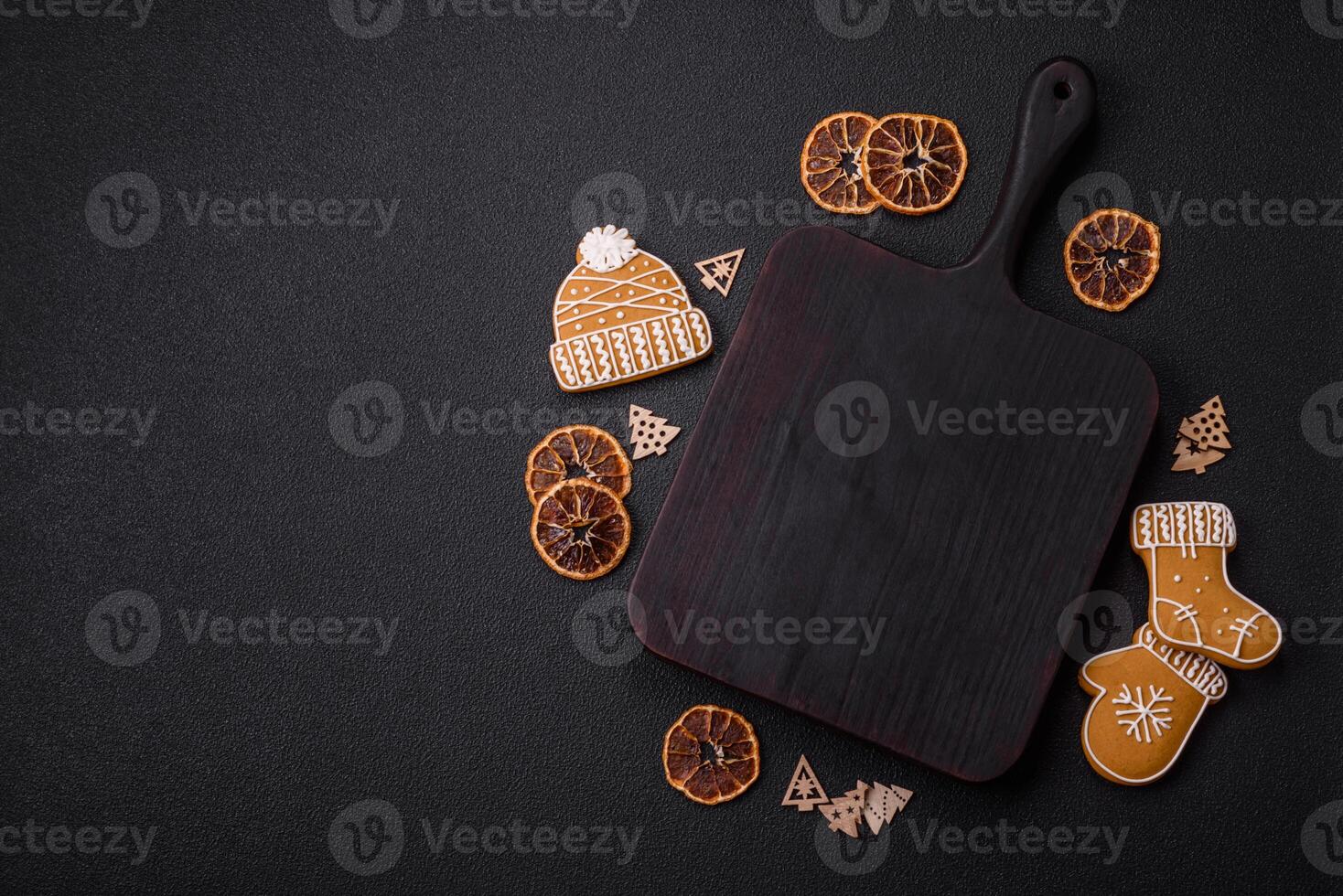 Empty wooden cutting board with copy space with gingerbread cookies and Christmas decor photo