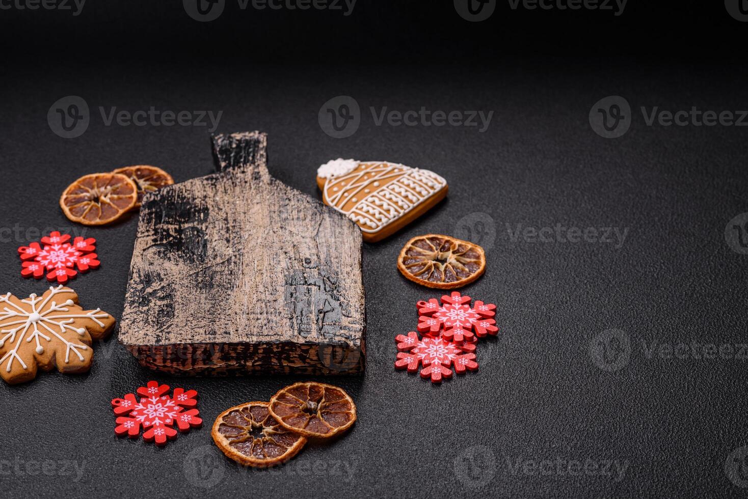 Empty wooden cutting board with copy space with gingerbread cookies and Christmas decor photo