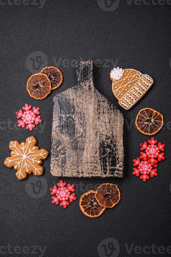 Empty wooden cutting board with copy space with gingerbread cookies and Christmas decor photo