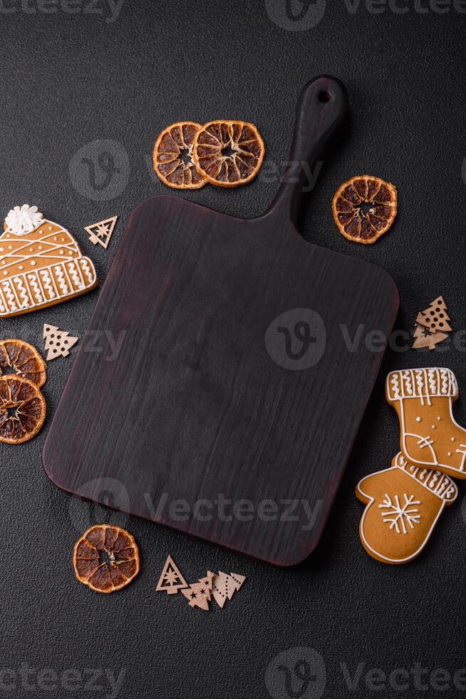 Empty wooden cutting board with copy space with gingerbread cookies and Christmas decor photo