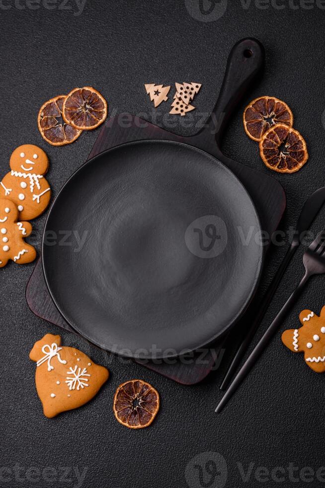 Empty round ceramic copy space plate with gingerbread cookies and Christmas elements photo