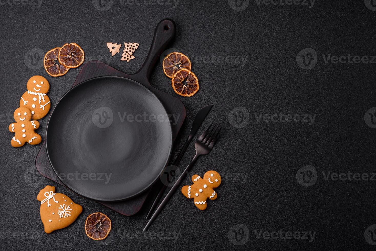 Empty round ceramic copy space plate with gingerbread cookies and Christmas elements photo