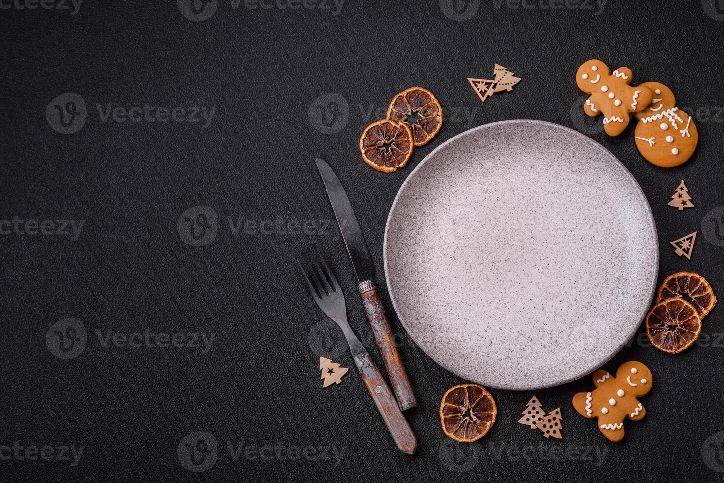 Empty round ceramic copy space plate with gingerbread cookies and Christmas elements photo