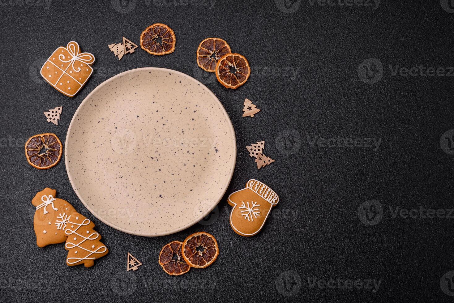 Empty round ceramic copy space plate with gingerbread cookies and Christmas elements photo