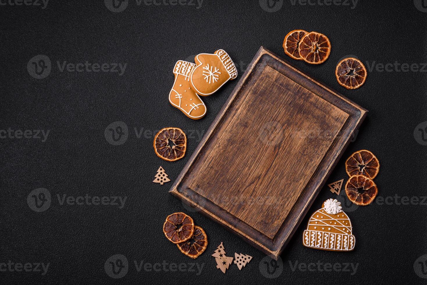 Empty wooden cutting board with copy space with gingerbread cookies and Christmas decor photo