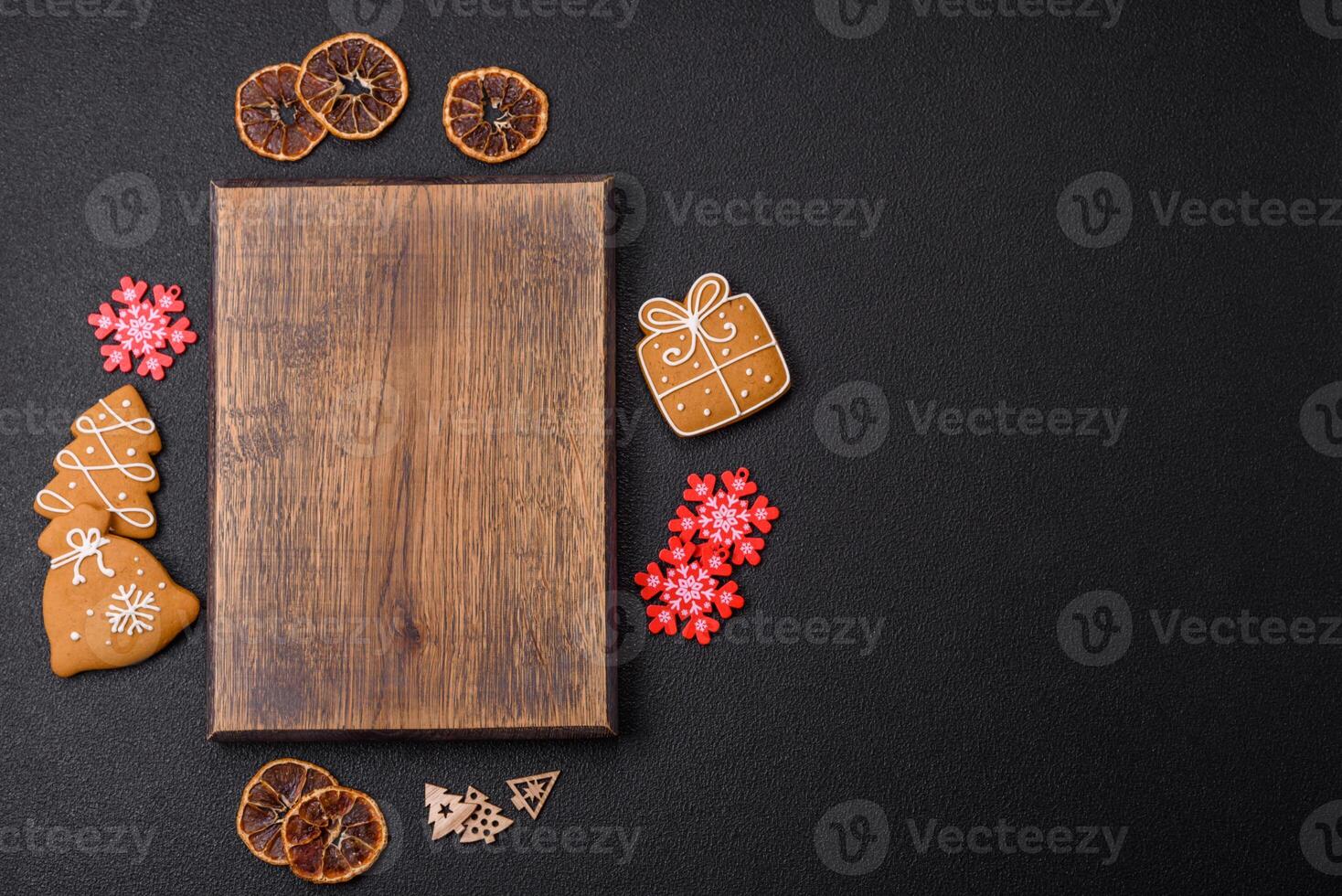 Empty wooden cutting board with copy space with gingerbread cookies and Christmas decor photo