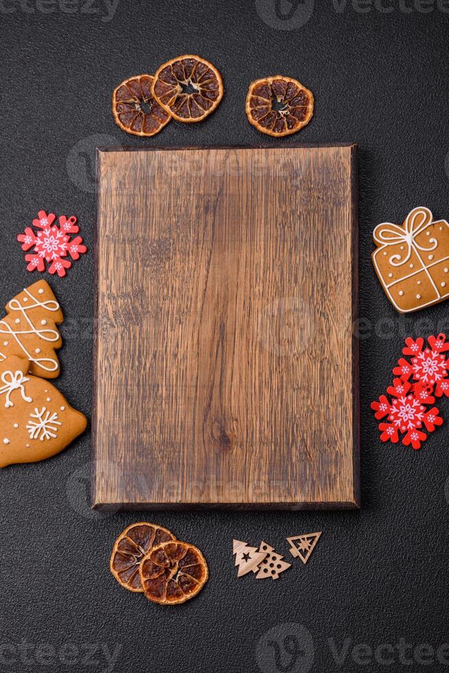 Empty wooden cutting board with copy space with gingerbread cookies and Christmas decor photo