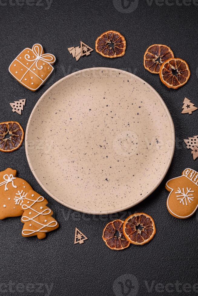 Empty round ceramic copy space plate with gingerbread cookies and Christmas elements photo
