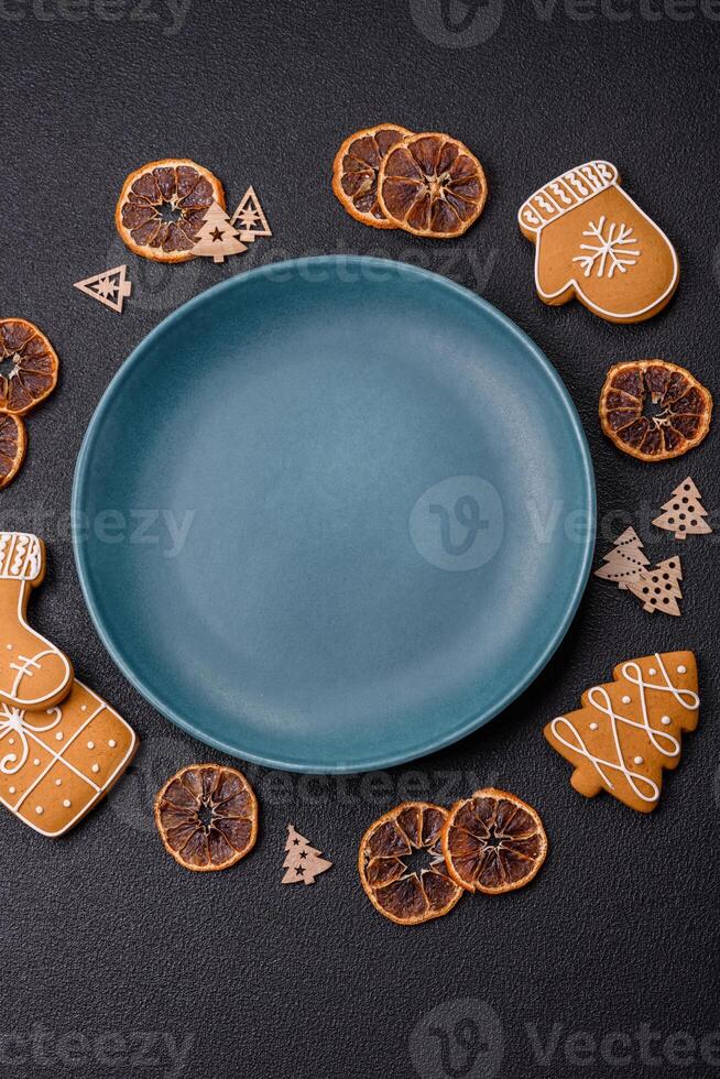 Empty round ceramic copy space plate with gingerbread cookies and Christmas elements photo
