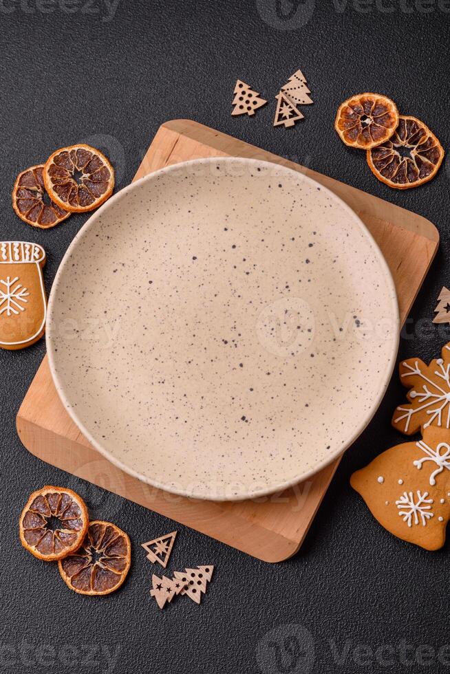 Empty round ceramic copy space plate with gingerbread cookies and Christmas elements photo