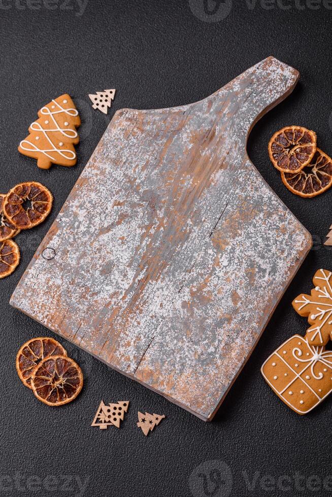 Empty wooden cutting board with copy space with gingerbread cookies and Christmas decor photo
