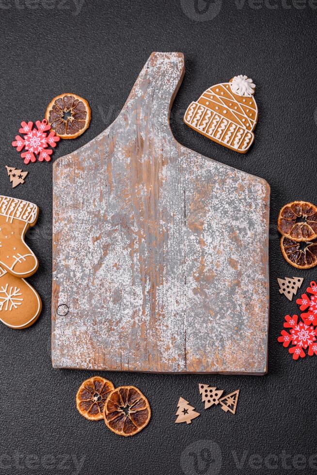 Empty wooden cutting board with copy space with gingerbread cookies and Christmas decor photo