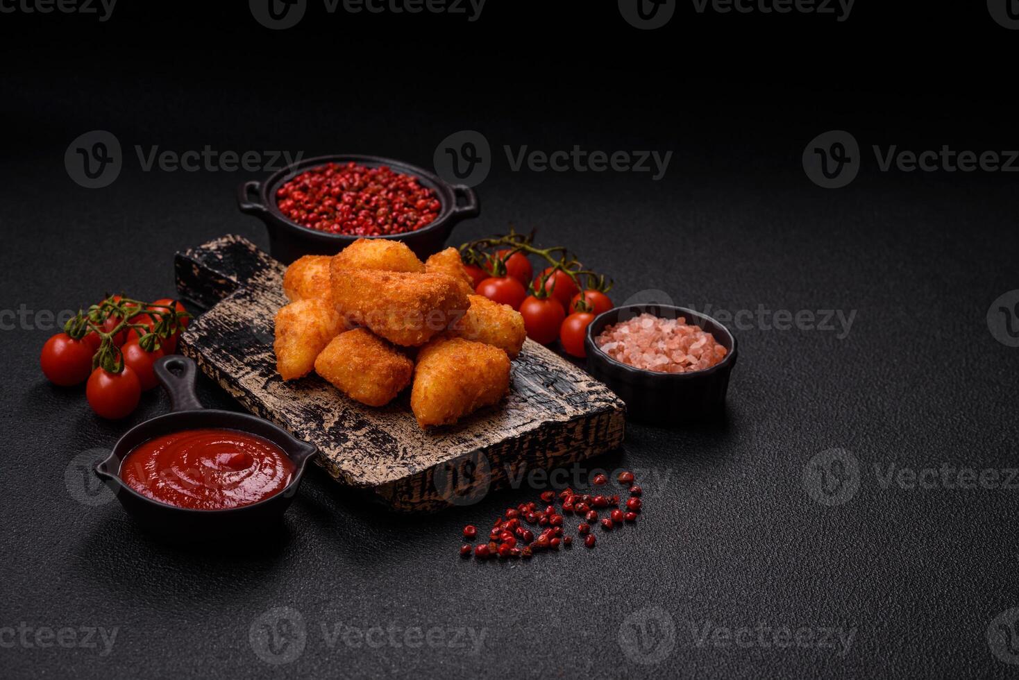 Breaded camembert or brie cheese baked in the form of nuggets with salt and spices photo