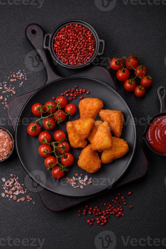 Breaded camembert or brie cheese baked in the form of nuggets with salt and spices photo