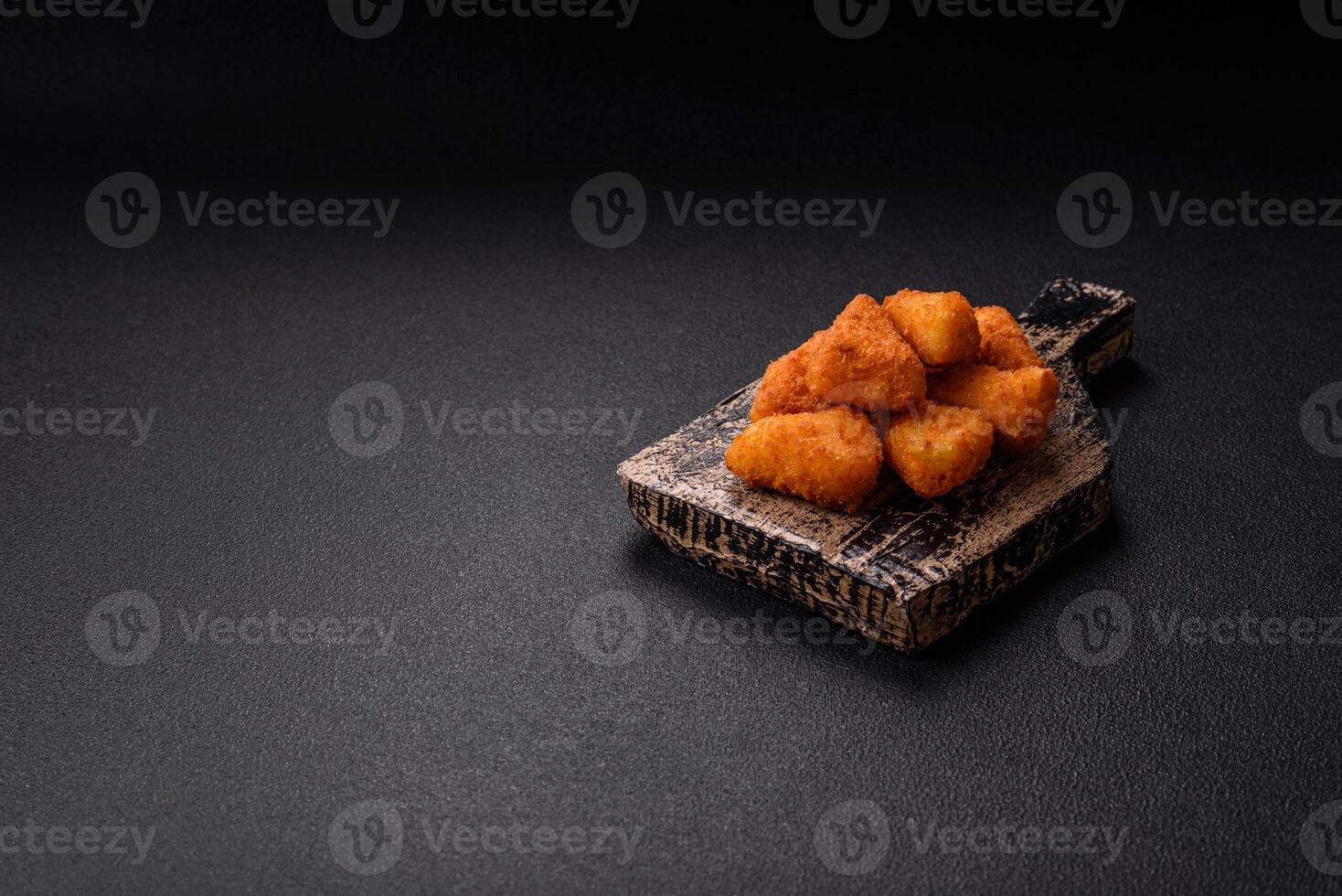 Breaded camembert or brie cheese baked in the form of nuggets with salt and spices photo