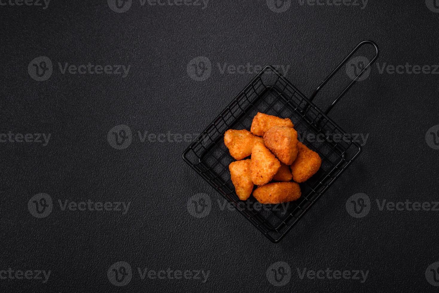 Breaded camembert or brie cheese baked in the form of nuggets with salt and spices photo