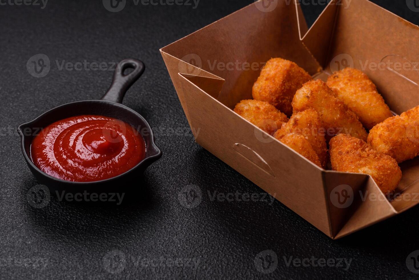 Breaded camembert or brie cheese baked in the form of nuggets with salt and spices photo