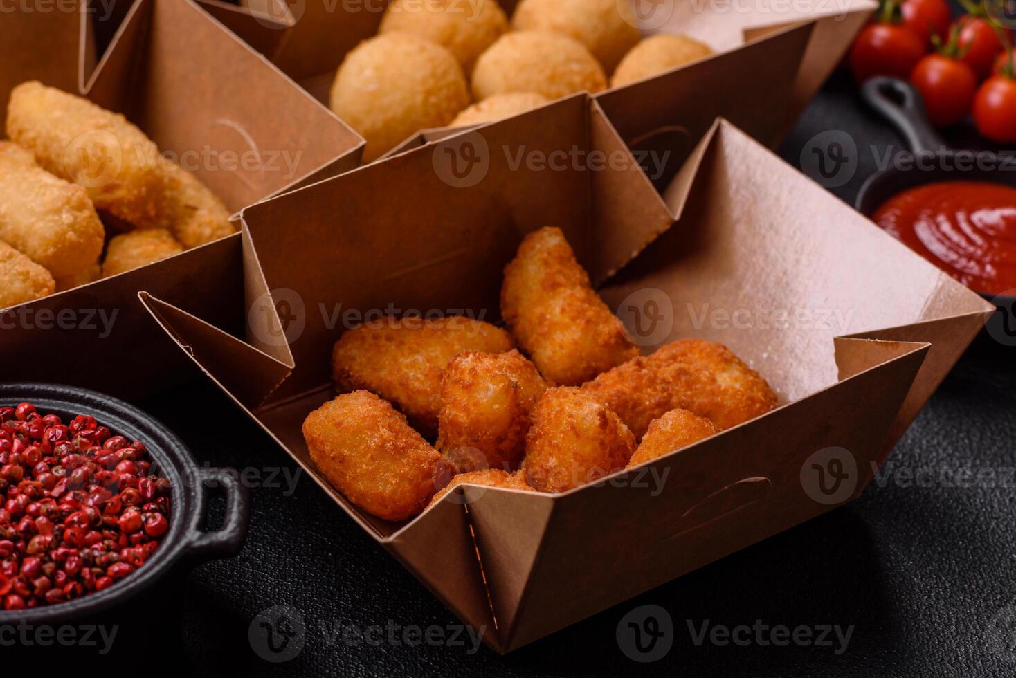 Fast food french fries, brie fries, cheese balls, cheese sticks and chicken nuggets photo