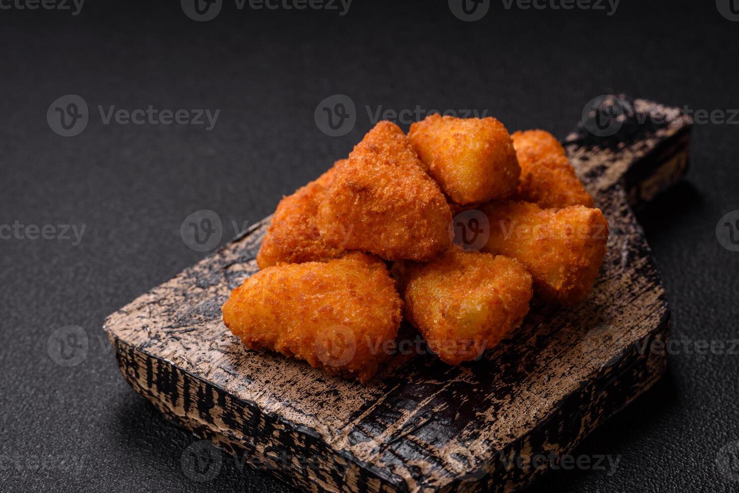 Breaded camembert or brie cheese baked in the form of nuggets with salt and spices photo