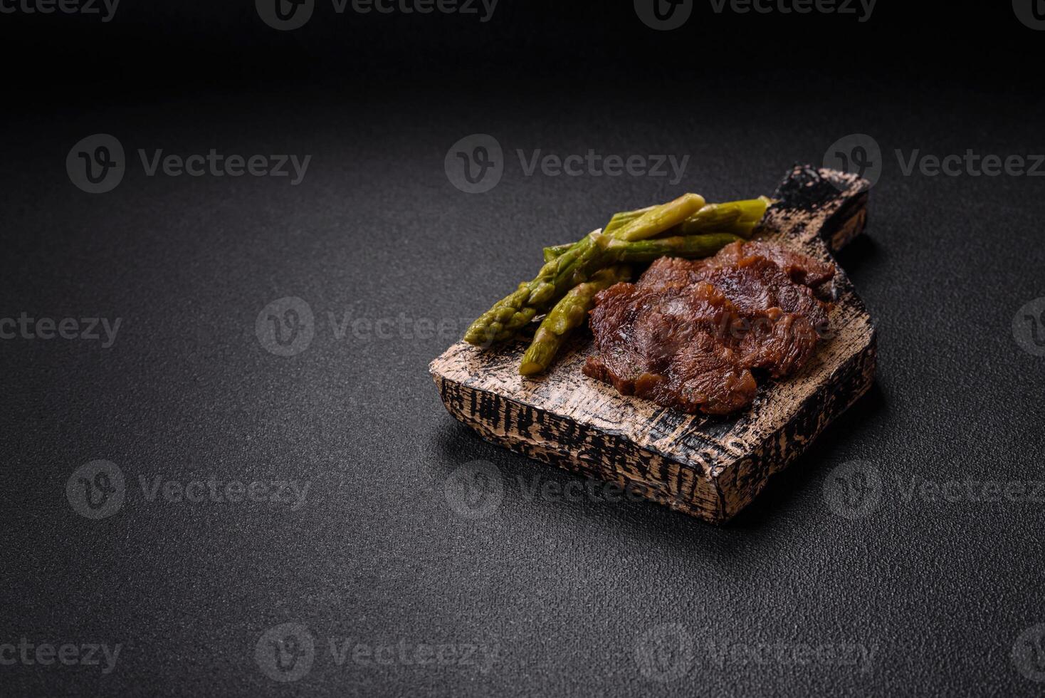Juicy beef or pork cut into slices with boiled asparagus photo