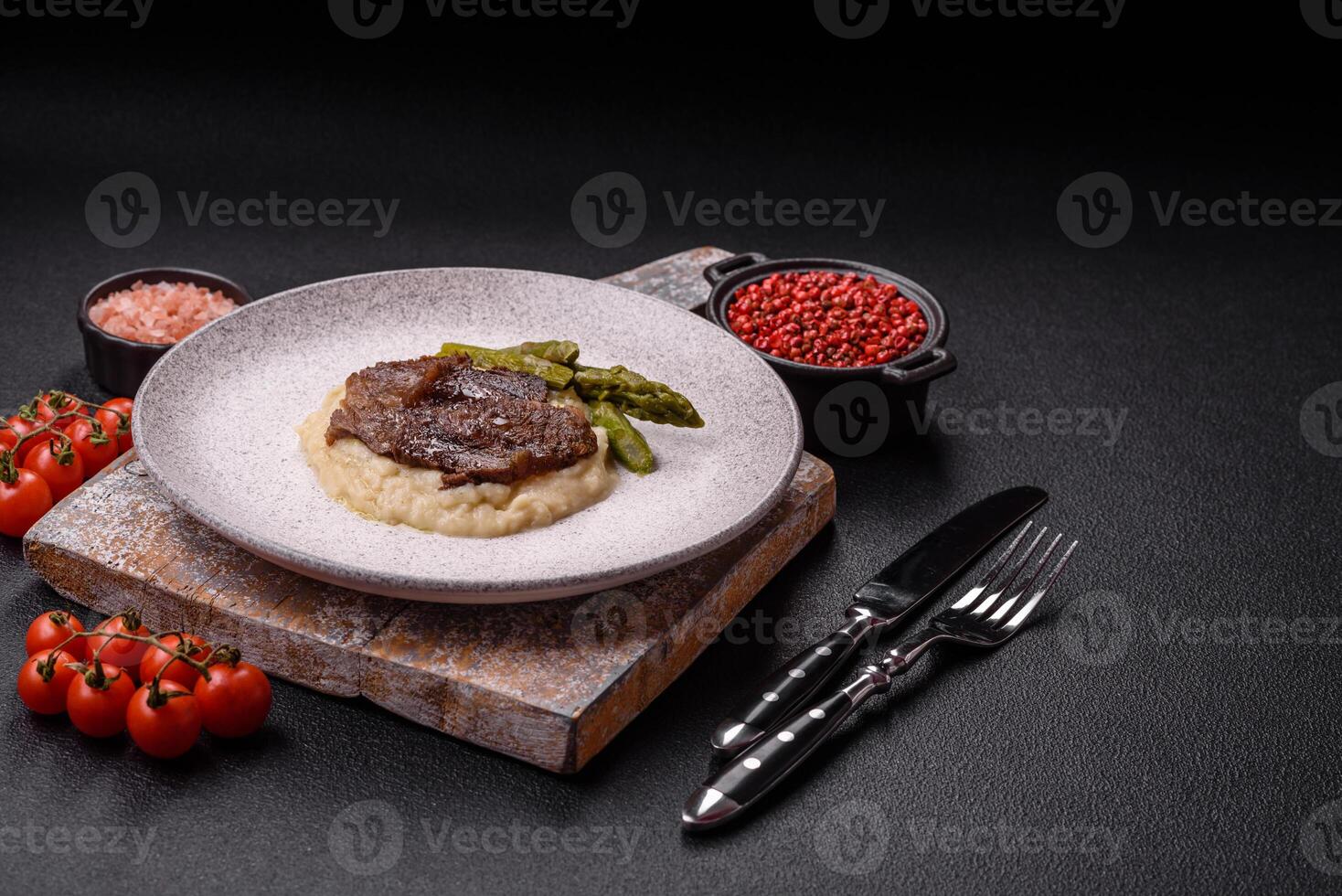 Juicy beef or pork cut into slices with boiled asparagus photo