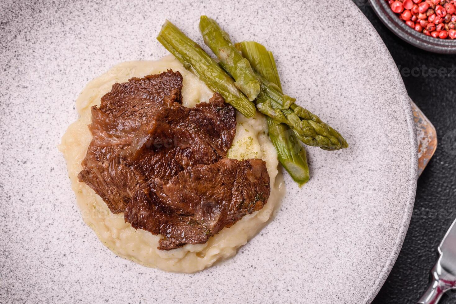 Juicy beef or pork cut into slices with boiled asparagus photo