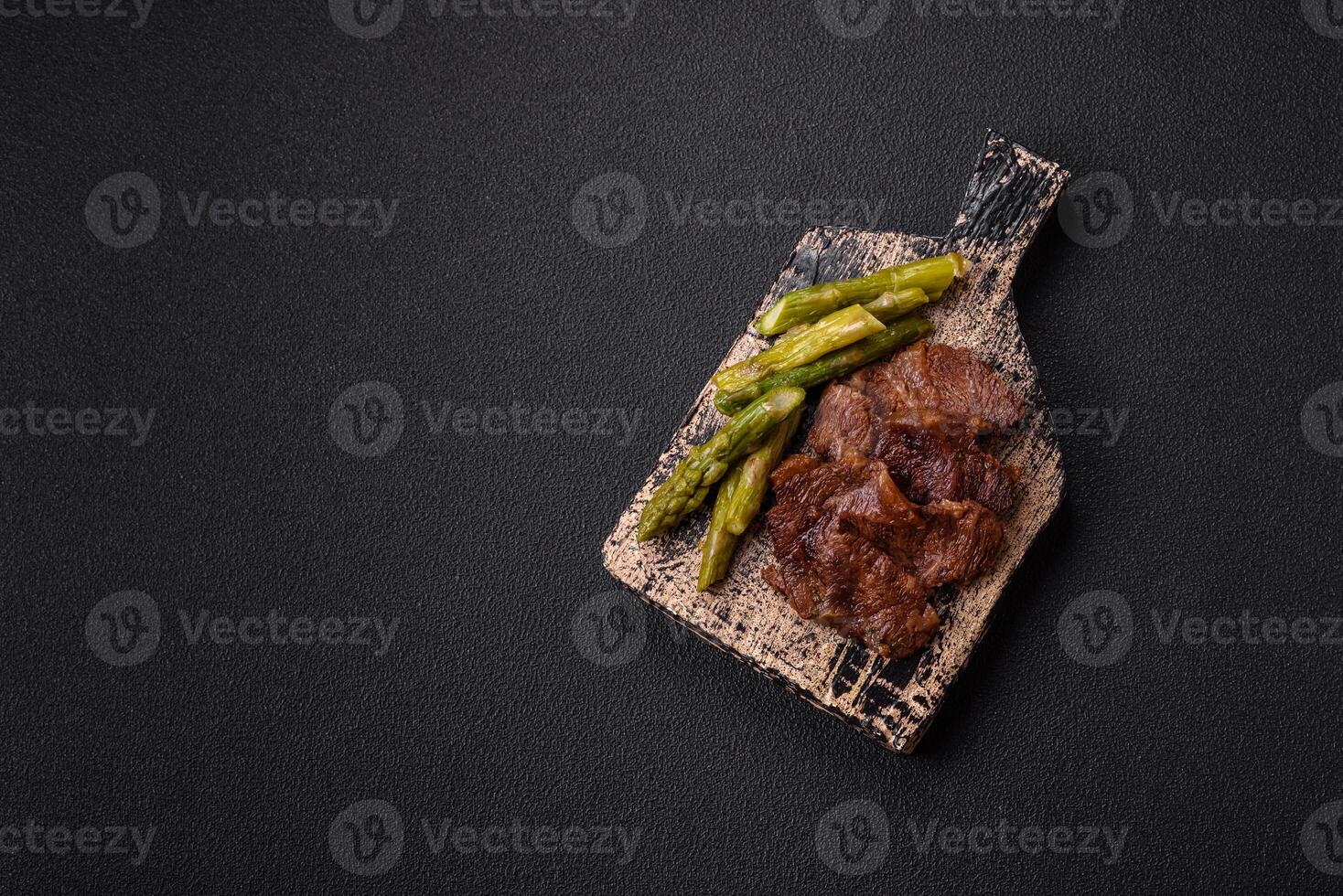 Juicy beef or pork cut into slices with boiled asparagus photo