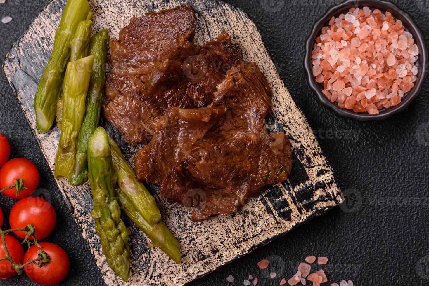 Juicy beef or pork cut into slices with boiled asparagus photo