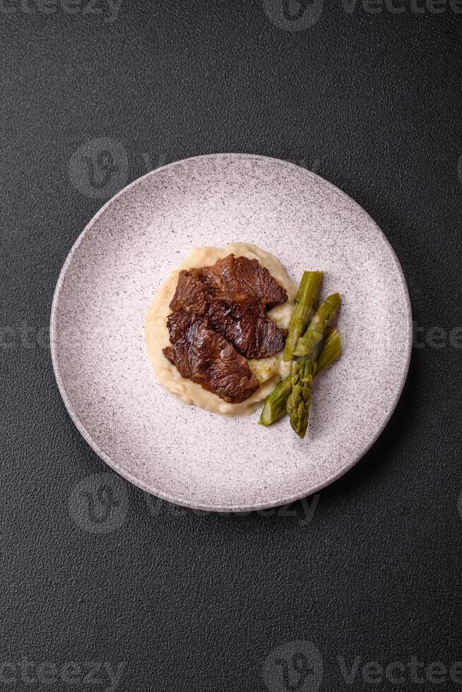 Juicy beef or pork cut into slices with boiled asparagus photo