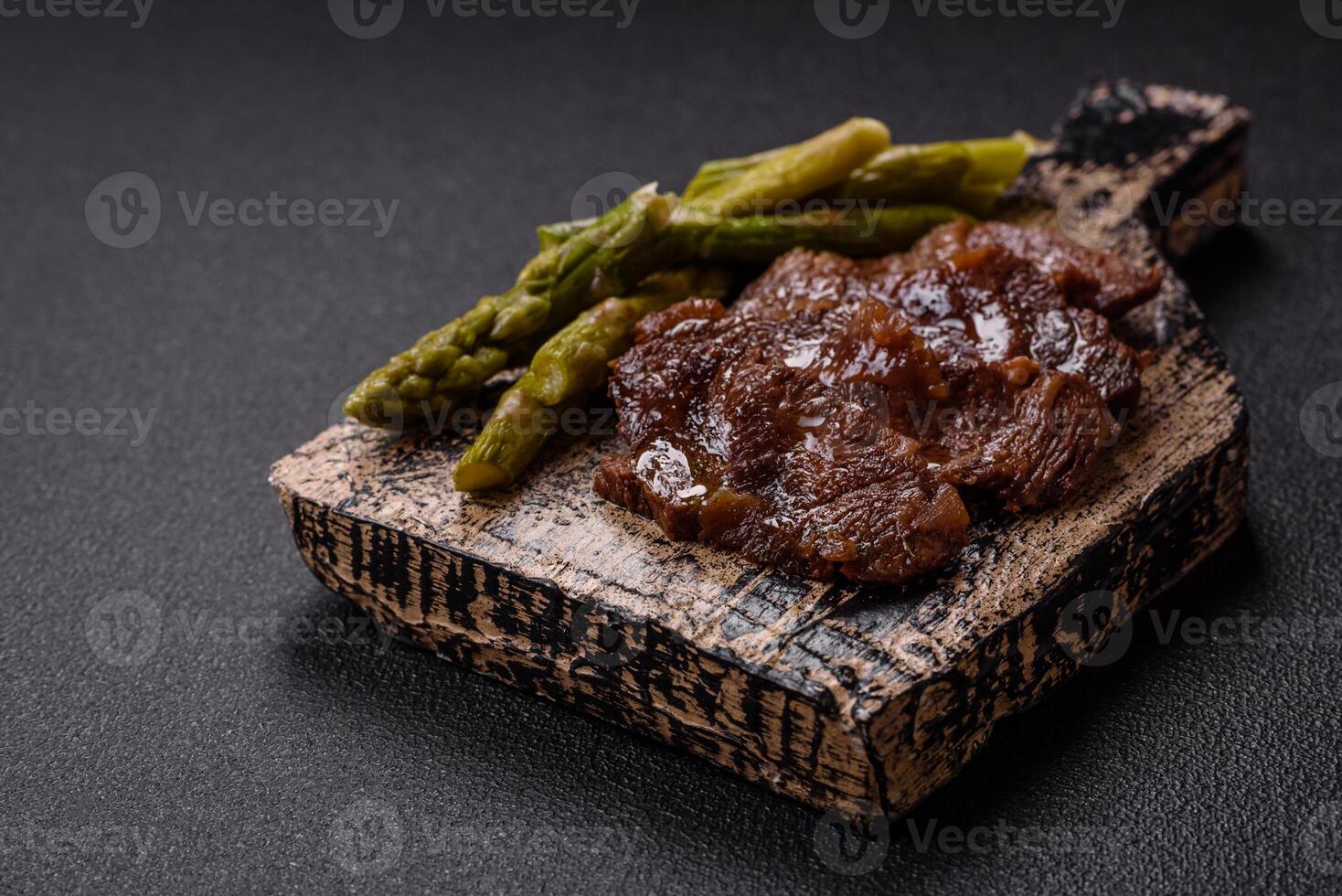 Juicy beef or pork cut into slices with boiled asparagus photo