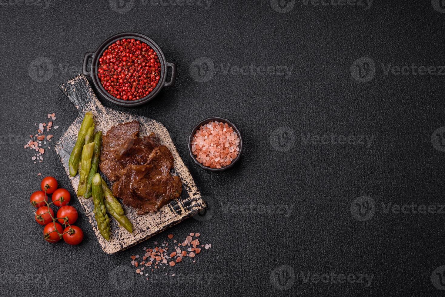 Juicy beef or pork cut into slices with boiled asparagus photo