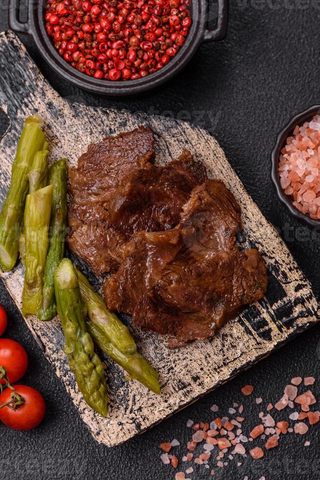 Juicy beef or pork cut into slices with boiled asparagus photo