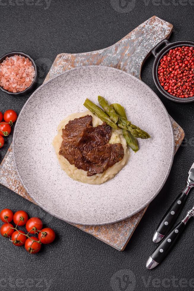 Juicy beef or pork cut into slices with boiled asparagus photo