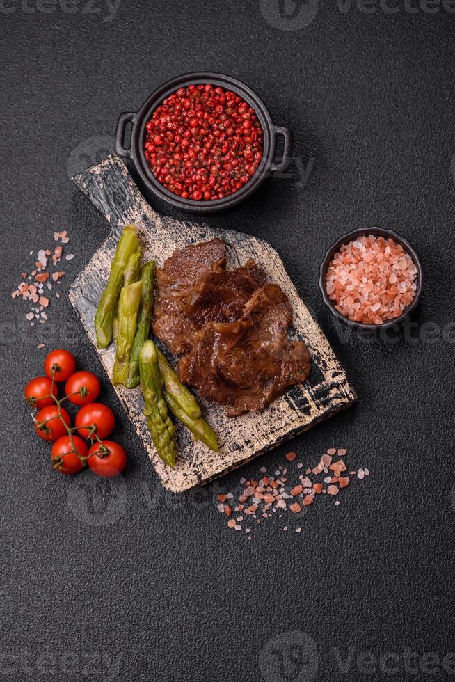 Juicy beef or pork cut into slices with boiled asparagus photo
