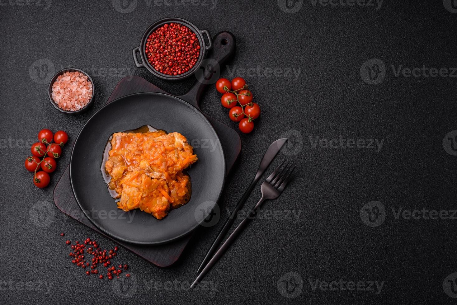 Sliced fish in tomato sauce with salt and spices photo