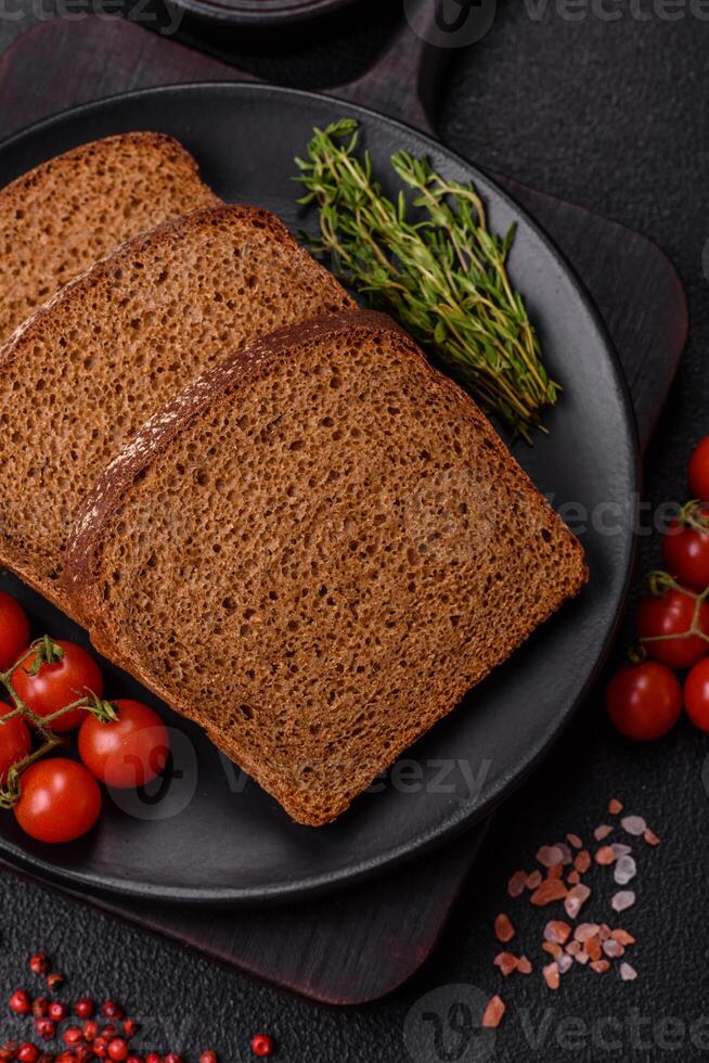 Fresh crispy brown bread sliced from whole grain flour photo