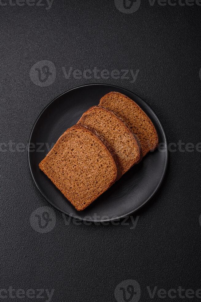 Fresh crispy brown bread sliced from whole grain flour photo