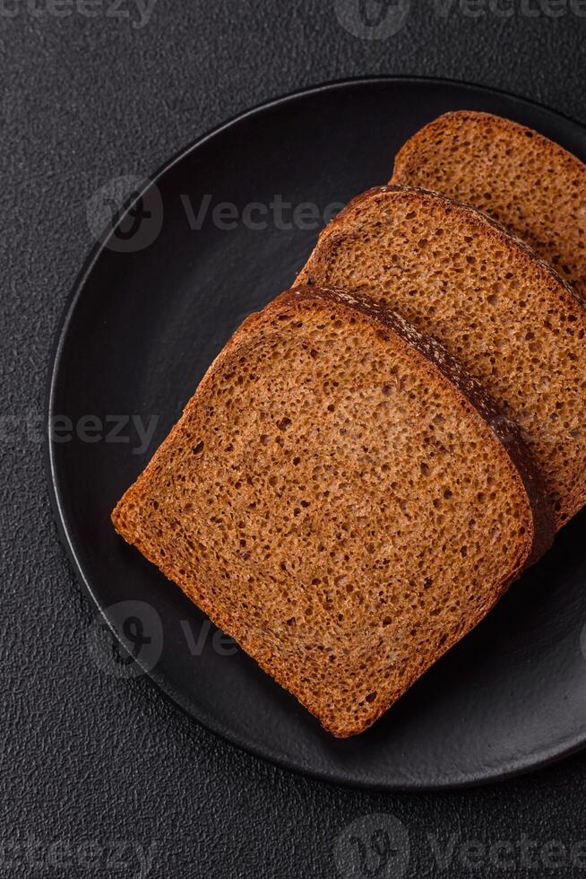 Fresh crispy brown bread sliced from whole grain flour photo