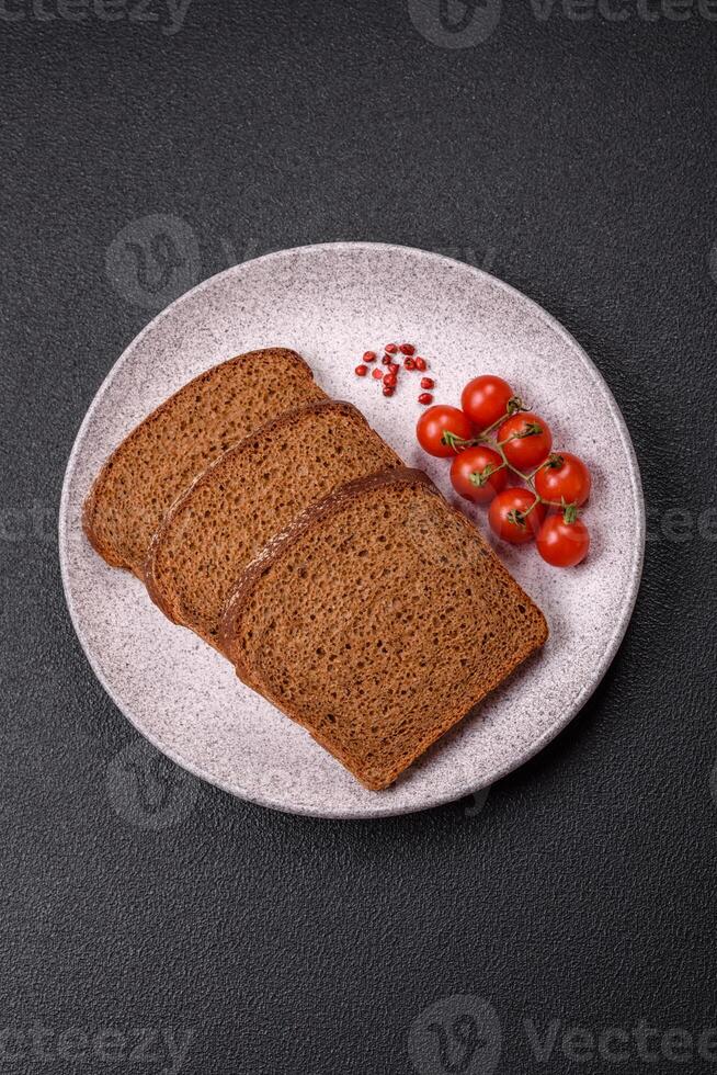 Fresh crispy brown bread sliced from whole grain flour photo