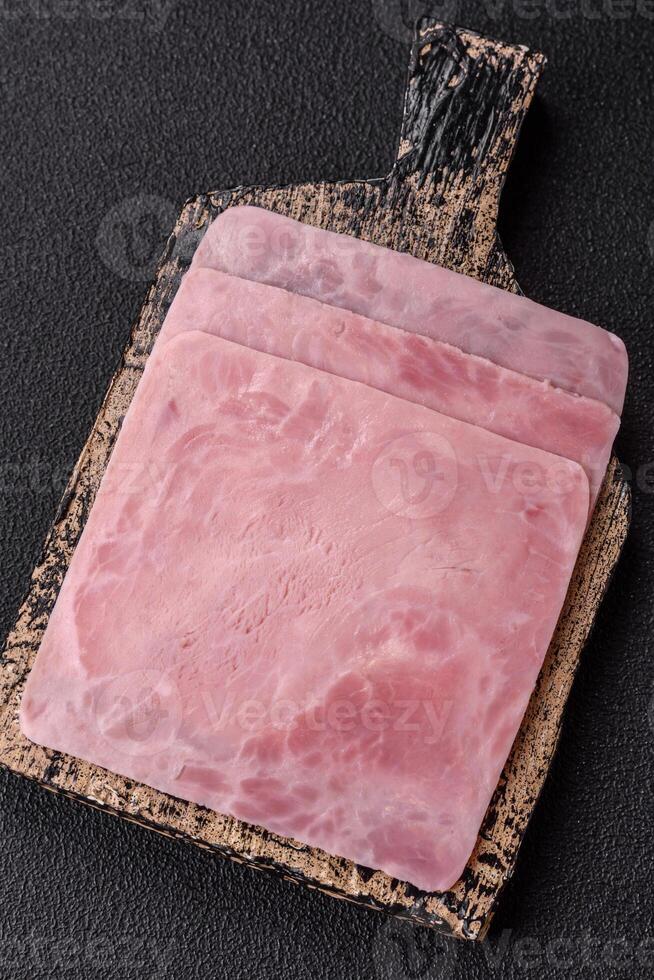 Ham cut into square slices for making delicious nutritious sandwiches photo